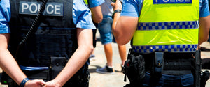 Two Australian police officers wearing tactical gear and high-visibility vests – Major Industries