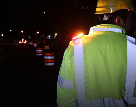 Guardian Angel wearable safety light worn by a roadside utility worker
